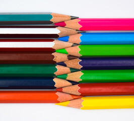 A zigzagged arrangement of two different row of different color wood pencil crayons