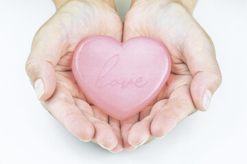 Fototapeta premium Vintage abstract wedding template with red card heart hands on pink background. Design element. Pink background. Greeting card