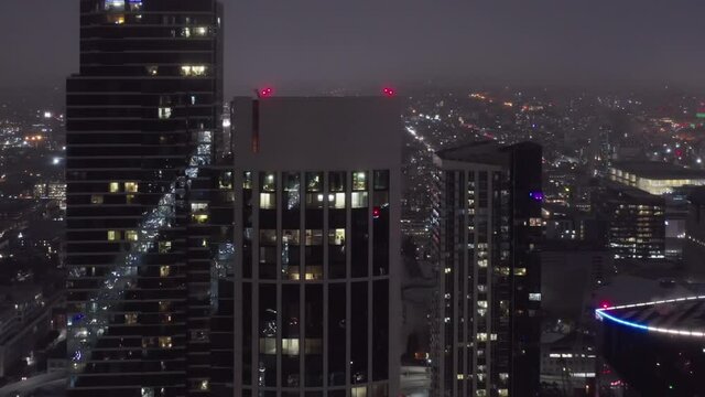 4K cinematic aerial panorama of beautiful downtown San Francisco at night. Illuminated buildings in purple clouds. Smart businessmen are in their residential skyscrapers with beautiful city view. USA