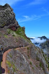 A trail on the tour from Pico do Arieiro to Pico Ruivo. Two hikers on the way. Madeira, Portugal.