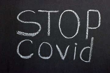 
Text on chalkboard Stop covid. A call to defeat the pandemic