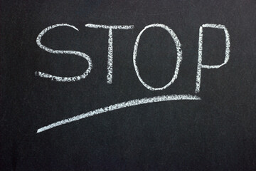 
Text on chalkboard Stop. Indication of a prohibitive action