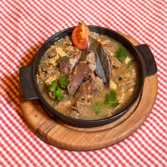 Tasty meat meal , soup on the black plate