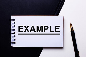 The word EXAMPLE is written in a white notebook on a black and white background. Motivation concept