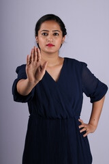 Beautiful Indian girl taking tough stance and saying no, stop with her gesture.