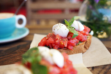 Bruschetta with tomatoes on a wooden board