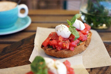 Bruschetta with tomatoes on a wooden board