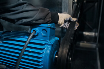 force test of the electric motor's drive belt.