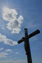 Jesus figure ( cruci fixus ) can be seen as a silhouette on a brown wooden cross. Motif runs...