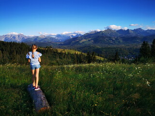 Naklejka premium Bukowina Podhale Poland. Little girl on the background of the Tatra Mountains. Holidays in the mountains.