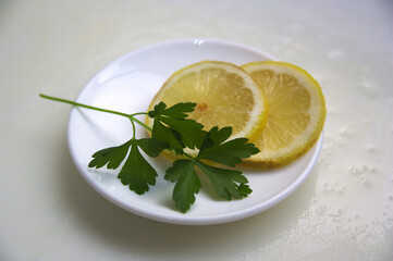 Two lemon slices and a sprig of parsley