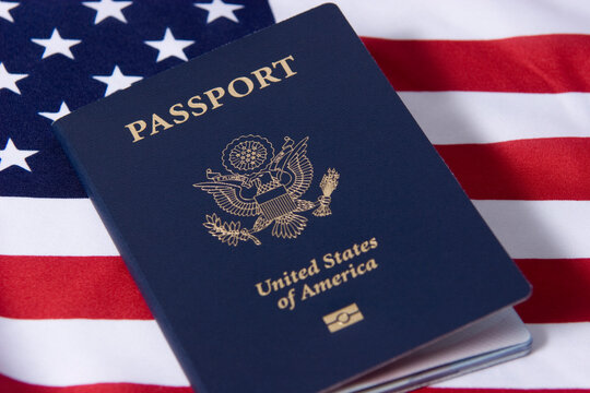 American passport against the U.S. flag