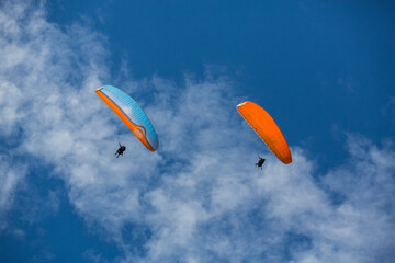 2 Tandem Gleitschirme vor blauem Himmel