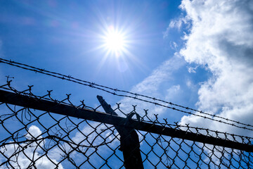 Sun and Chainlink Fence