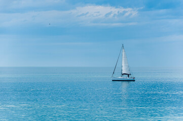 a sailboat anchored off the coast of Mar del Plata, Argentina, on a sunny day