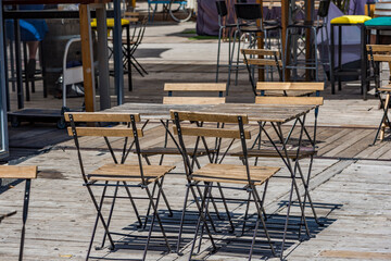 Wooden empty table for 4 persons of street cafe. Jerusalim.