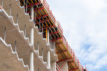 Construction site with a new modern building made with concrete as city development and futuristic...
