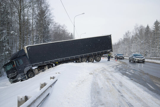 LENINGRAD REGION, RUSSIA - MARCH 21, 2018: Mercedes-Benz Axor 1836 with trailer in a ditch in March snowfall