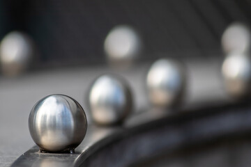 Matt steel balls in a row as decorative and ornamental balustrade and futuristic fence design with...