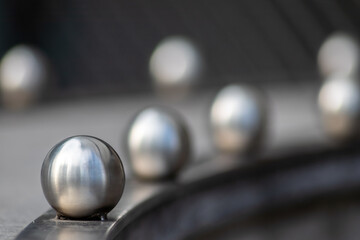 Matt steel balls in a row as decorative and ornamental balustrade and futuristic fence design with...