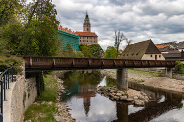 Fototapeta na wymiar český krumlov, czech republic. View to castle tower in the ancient bohemian village with antique houses. Landscape with blue sky and clouds