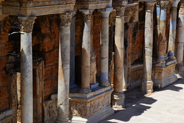 An old Roman Empire amphitheater against a blue sky on a bright Sunny day