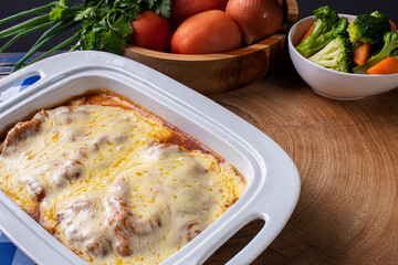 Parmegiana Steak also known as Filet Parmegiana. .Accompanied by vegetable salad