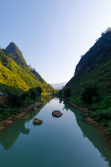 Fototapeta na wymiar River Song Lo in Ha Giang Province, Vietname at Bridge Cầu Cán Tỷ