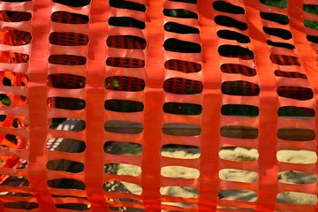 Plastic safety construction fence. Perforated plastic foil preventing entry to an playground....