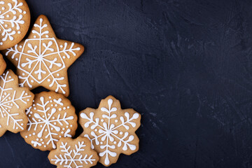 gingerbread snowflakes on a black background, top view. new year gingerbread background