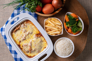 Parmegiana Steak also known as Filet Parmegiana. .Accompanied by vegetable salad, rice and french fries