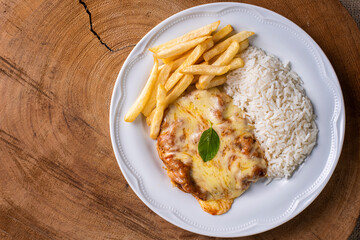 Parmegiana Steak also known as Filet Parmegiana. .Accompanied by rice and chips