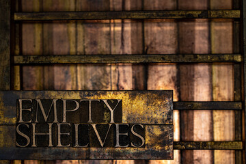 Empty Shelves text formed with real authentic typeset letters on vintage textured silver grunge copper and gold background