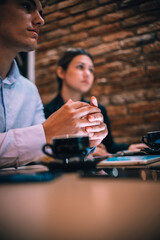Happy millennial couple listens carefully to their financial consultant over a coffee meeting