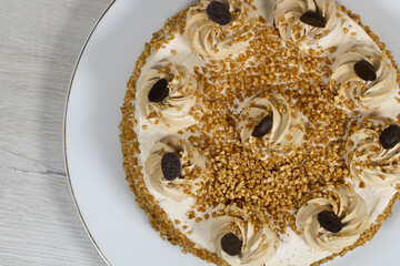 Cake "Ladies' whim" on a background of bleached wood.