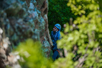 Young man finishing his extreme mountain climb