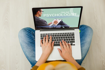 Woman in front of her laptop having an online call with her therapist, text space