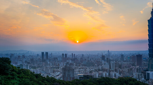 Magnificent panoramic view of sunset with colorful cloudy sky over modern city with skyscrapers in summer evening in Taiwan