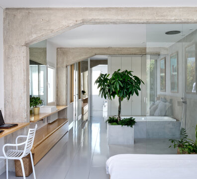 Interior of contemporary bathroom with geometric ceiling and comfortable furniture