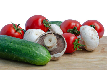 Tomatoes cucumbers mushrooms. Fresh vegetables and mushrooms on a white background.