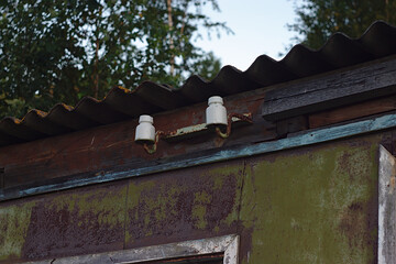 electrical insulators on an old ruined farm building