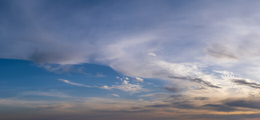 Fototapeta premium Fluffy clouds in evening overcast sky panoramic view. Climate, environment and weather concept sky background.