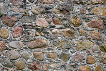 Stone wall texture background. Fragment of a massive wall of an ancient building.