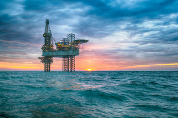 Oil rig at sunset time