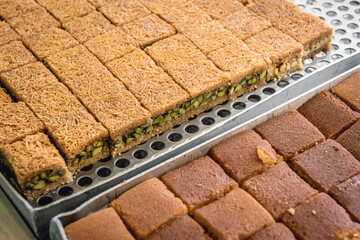 Close up on a plate with type of Arabic sweets Baklava with pistachio nuts in sweet shop in Lebanon