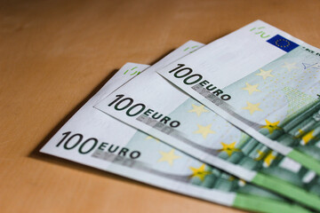 Close-up of 100 Euro banknotes isolated on white background. Currency, financial