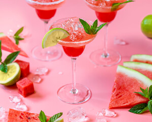 Delicious cocktail with watermelon and lime on pink background.