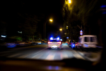 Distorted image of police car with emergency lights on