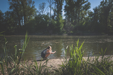 little child in the sandy beach of the river Danube
