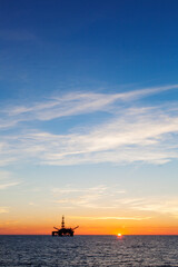Oil platform at sunset, vertical view